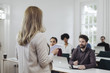 © LStockStudio - Businesswoman Presenting in Front of Audience