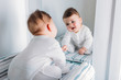 © N3ho_Photo/ADDICTIVE STOCK - Baby boy sitting near mirror and looking at his reflection