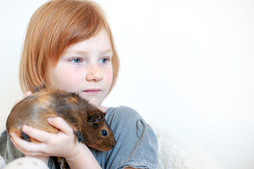 Wall Mural - Girl playing with guinea pig