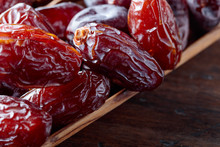 Juicy Dates On Wooden Table .