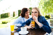 © Alvin Harambašić - Young romantic couple spending time together - sitting in cafe's garden, drinking juice and having fun