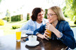 © Alvin Harambašić - Young romantic couple spending time together - sitting in cafe's garden, drinking juice and having fun