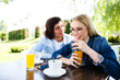 © Alvin Harambašić - Young romantic couple spending time together - sitting in cafe's garden, drinking juice and having fun