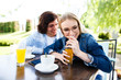 © Alvin Harambašić - Young romantic couple spending time together - sitting in cafe's garden, drinking juice and having fun