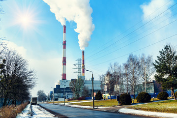 smoking factory pipes on the blue sky background