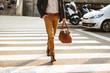© Drobot Dean - Cropped photo of stylish successful man in business wear walking through pedestrian crossing in downtown, with leather male bag in hand