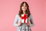 Fototapeta Na ścianę - Cute young pretty woman holding surprise gift present box.