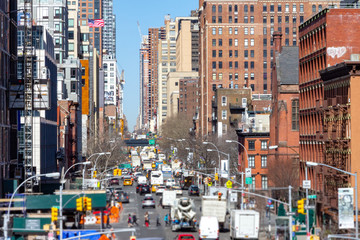 Wall Mural - Overhead view down 10th Avenue with people and cars lining the streets through the Chelsea neighborhood of Manhattan in New York City