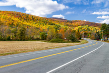 Empty Highway Road Through Colorful Fall Forest Landscape In New England