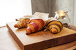 © Ogovorka - fresh croissants with jam and almonds for breakfast