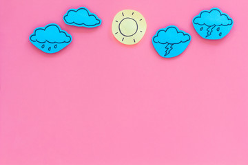 Wall Mural - weather forecast concept. modern weather icons set on pink background top view copy space