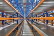 © Suslov Denis - Empty shelves in new distribution warehouse. Metal equipment for storage, racks blue orange, pallet racking system