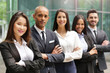 © Kitreel - Portrait of business people of different ethnic backgrounds dressed in suits, they smile and cross their arms. Concept of: internationality and career, cooperation and team.