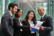 © Kitreel - Business people from different ethnic groups dressed in suits, talk about the performance of the financial markets and the world economy. Concept of: internationality and career, cooperation