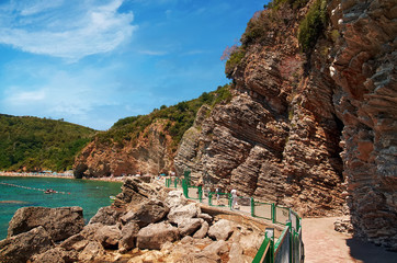 Footpath  in the rocks from Old Town Budva to famous small bay with Mogren Beach in Montenegro. Panoramic view on tourist route