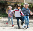 © JackF - Kids playing street football outdoors together