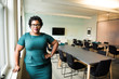 © R. Dione Foto/Creative Flame - Portrait of businesswoman standing in office