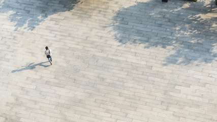 Wall Mural - Crowd of people walk on open space concrete pavement from top view ,bird eye view