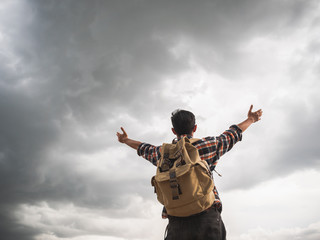 Wall Mural - A man travel outdoor nature with storm cloudy background.