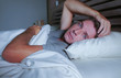 © TheVisualsYouNeed - restless worried young attractive man awake at night lying on bed sleepless with eyes wide opened suffering insomnia sleeping disorder depressed