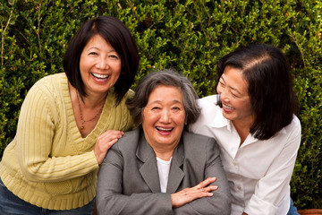 Mature Asian mother and her adult daughters.