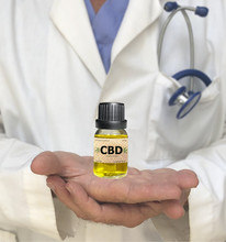 Doctor Hands Holding Cannabis CDB Oil