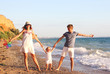 © Photo-Che - Family having fun playing on the beach at sunset. Family, colour, vacation concept.