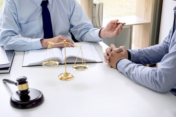 Wall Mural - Judge gavel with scales of justice, Business people and male lawyers discussing contract papers at law firm in office. Concepts of law