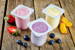 Variation of fruit yoghurts: strawberry, blueberry and peach