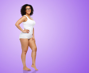 body positive and people concept - happy african american woman in white underwear over ultra violet background