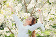© Volodymyr Shcherbak - Young beautiful blonde woman in blooming almonds garden.