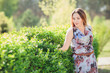 © Volodymyr Shcherbak - Young woman enjoying spring in the green field with blooming trees
