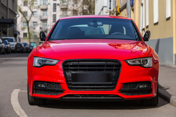 Poster - red luxury car parked on city