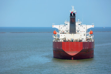 Red color oil product tanker at anchor in the port of Houston.