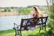 © Volodymyr Shcherbak - Young beautiful woman sitting on bench in park pretty girl at outdoors on summer day nature. attractive girl in park sitting on bench and relaxing in autumn day. Close up