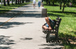 © Srdjan - Poor barefoot homeless man or refugee sleeping on the wooden bench on the urban street in the city, social documentary concept, selective focus
