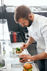 Wall Mural - Chef Cooking Burgers in Kitchen