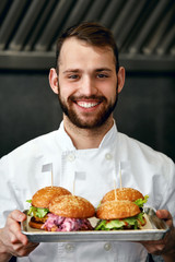 Wall Mural - Chef With Burgers In Restaurant Kitchen