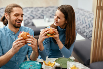 Wall Mural - People Having Dinner, Eating Burgers At Cafe