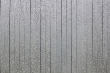 wall of gray aluminum sheets, close-up