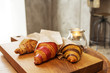 © Ogovorka - fresh croissants with jam and almonds for breakfast