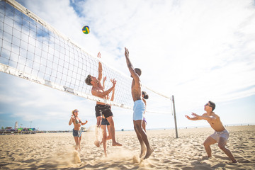 Friends play beach volley