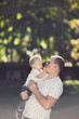 © VAKSMANV - Father and son playing in the park at the sunset time.