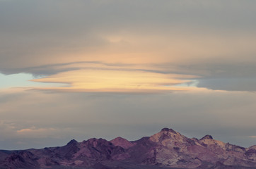 Wall Mural - Morning lenticular clouds in the Mojave Desert in California.