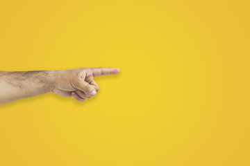 Wall Mural - Hand gesture. Pointing finger on orange background