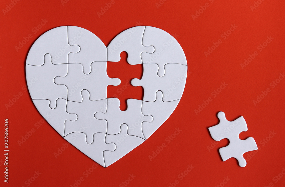 A missing piece of the puzzle and puzzles in the shape of a white heart ...