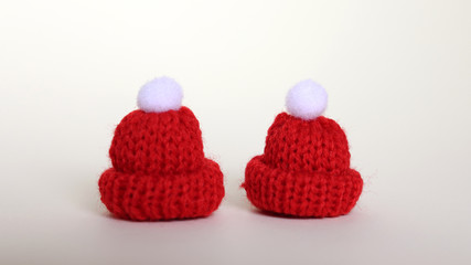 Close-up image of two red wool hats.