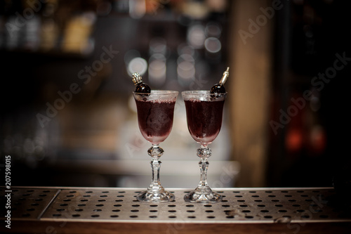 Fotografie, Obraz Two elegant glasses filled with sweet and strong Arnaud cocktail