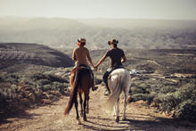 Love And Friendship Concept Outdoor For People Ride Horses In The Countryside. Amazing Landscape And A World To Discover Traveling Together. Caucasian Man And Woman