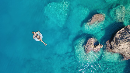 Wall Mural - aerial view at the girl on sea surface. beautiful composition at the summer time